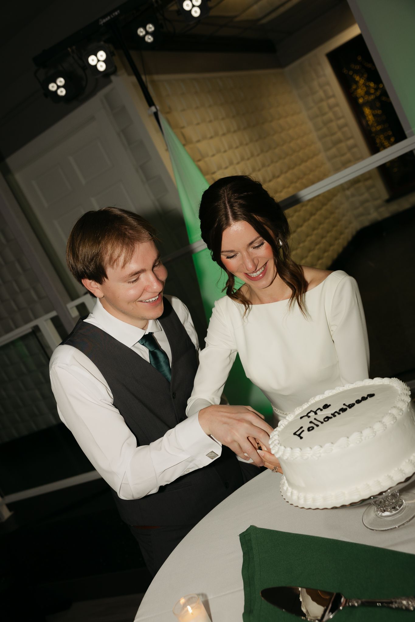 Couple cutting their wedding cake together at the reception.