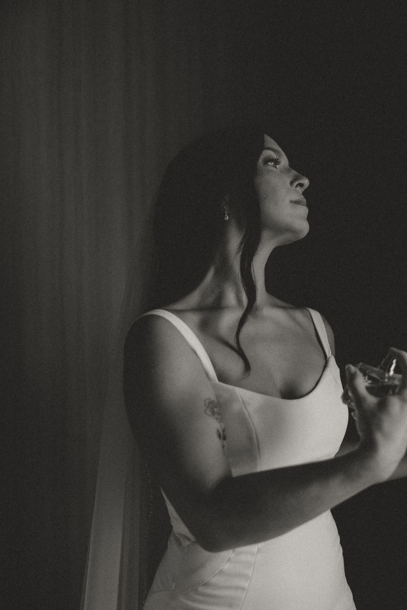 Dramatic black and white boudoir photography with moody lighting.