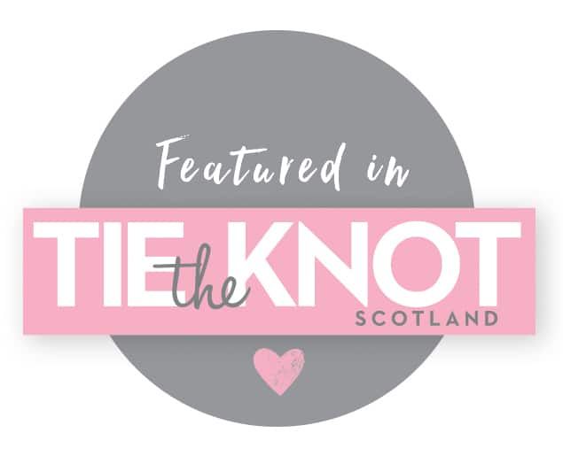 Pink and gray circular badge for 'The Knot Scotland' wedding publication featuring a small heart icon.