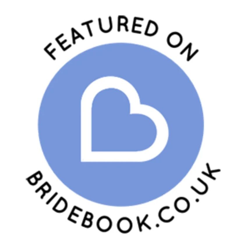 Blue circular badge with heart icon for Bridebook.co.uk wedding platform.