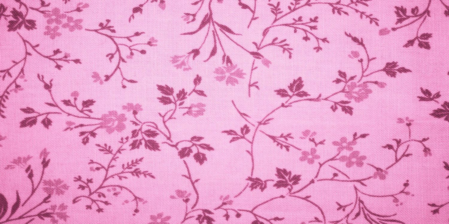 Pink floral fabric with delicate dark pink vine and flower pattern on a light pink background.
