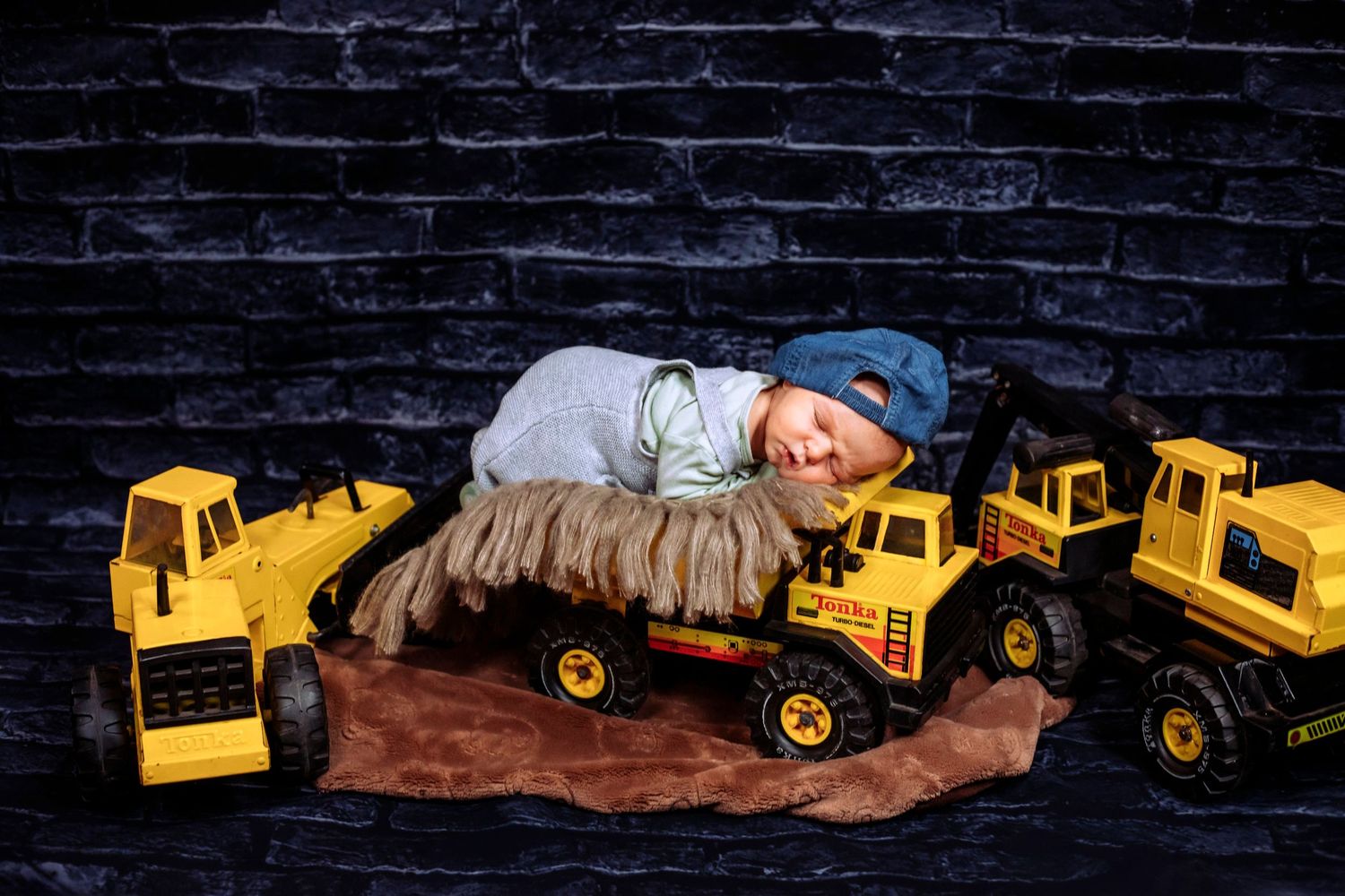 Newborn baby boy posed on Tonka construction trucks by Atlantic Memories Photography, South Shore Nova Scotia newborn photographer