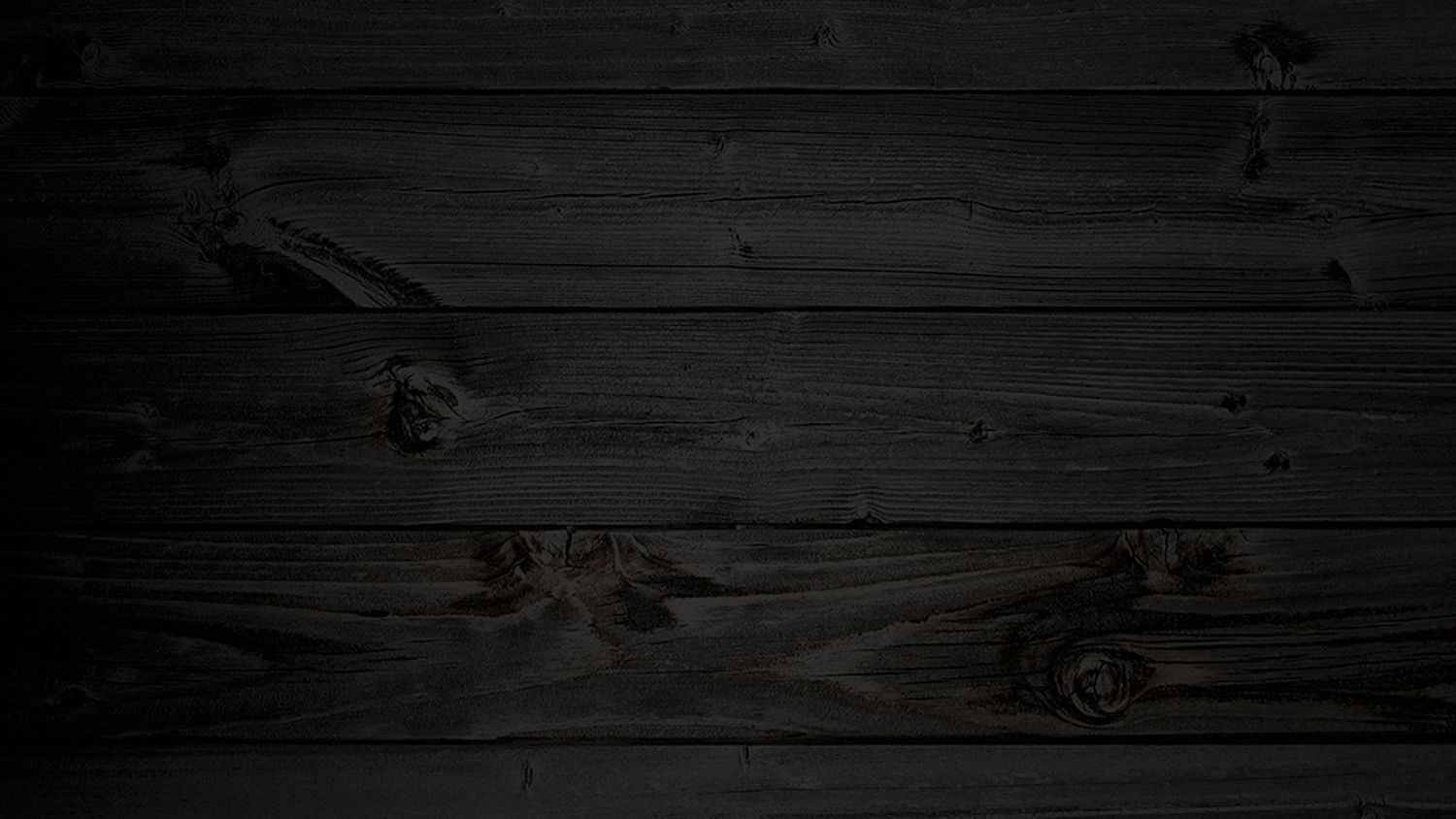 Dark black wooden plank wall texture background with natural grain patterns for rustic design projects.