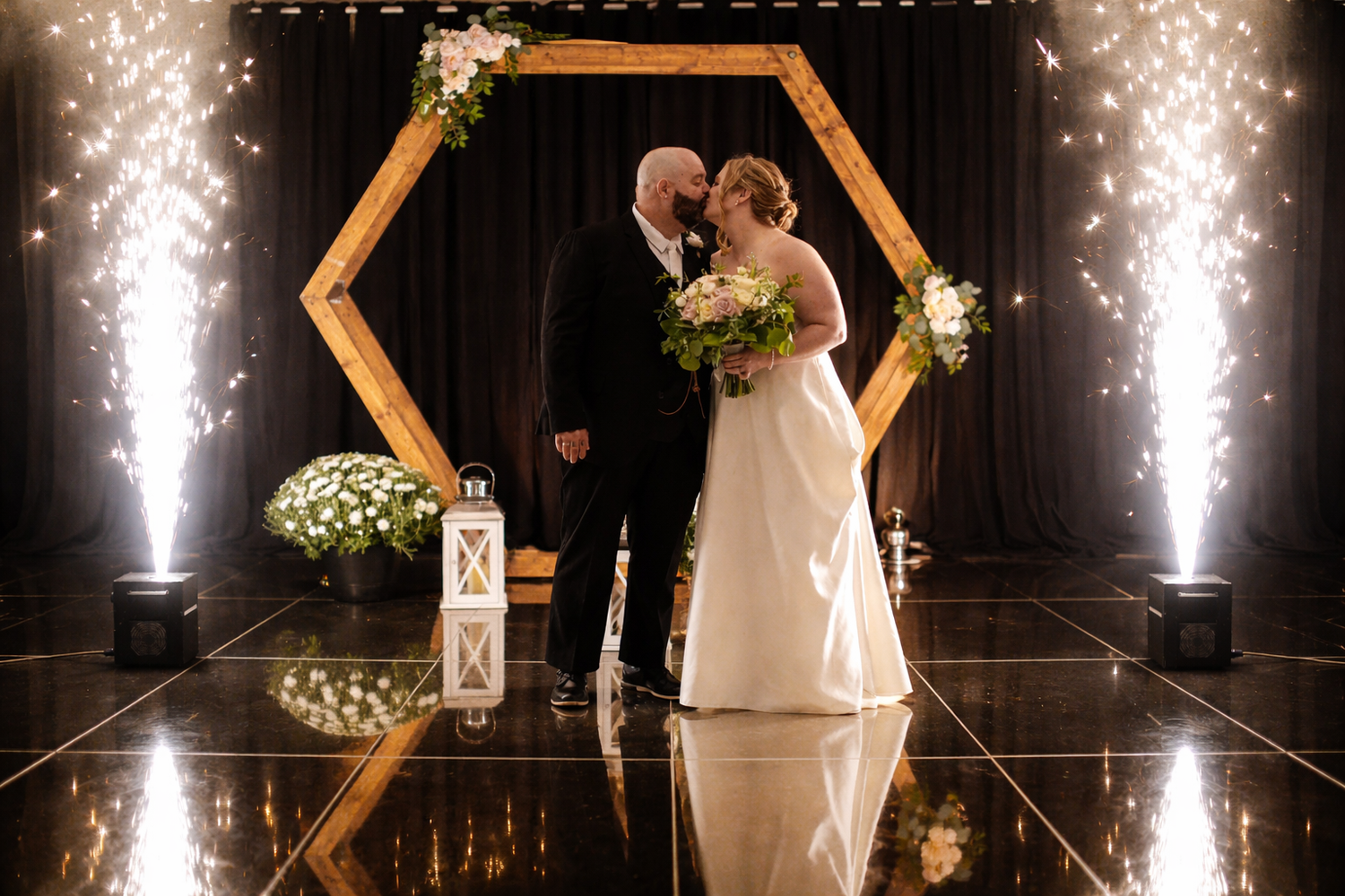 Bride and groom sharing a romantic wedding kiss surrounded by indoor sparkler in Nova Scotia captured by Atlantic Memories Photography