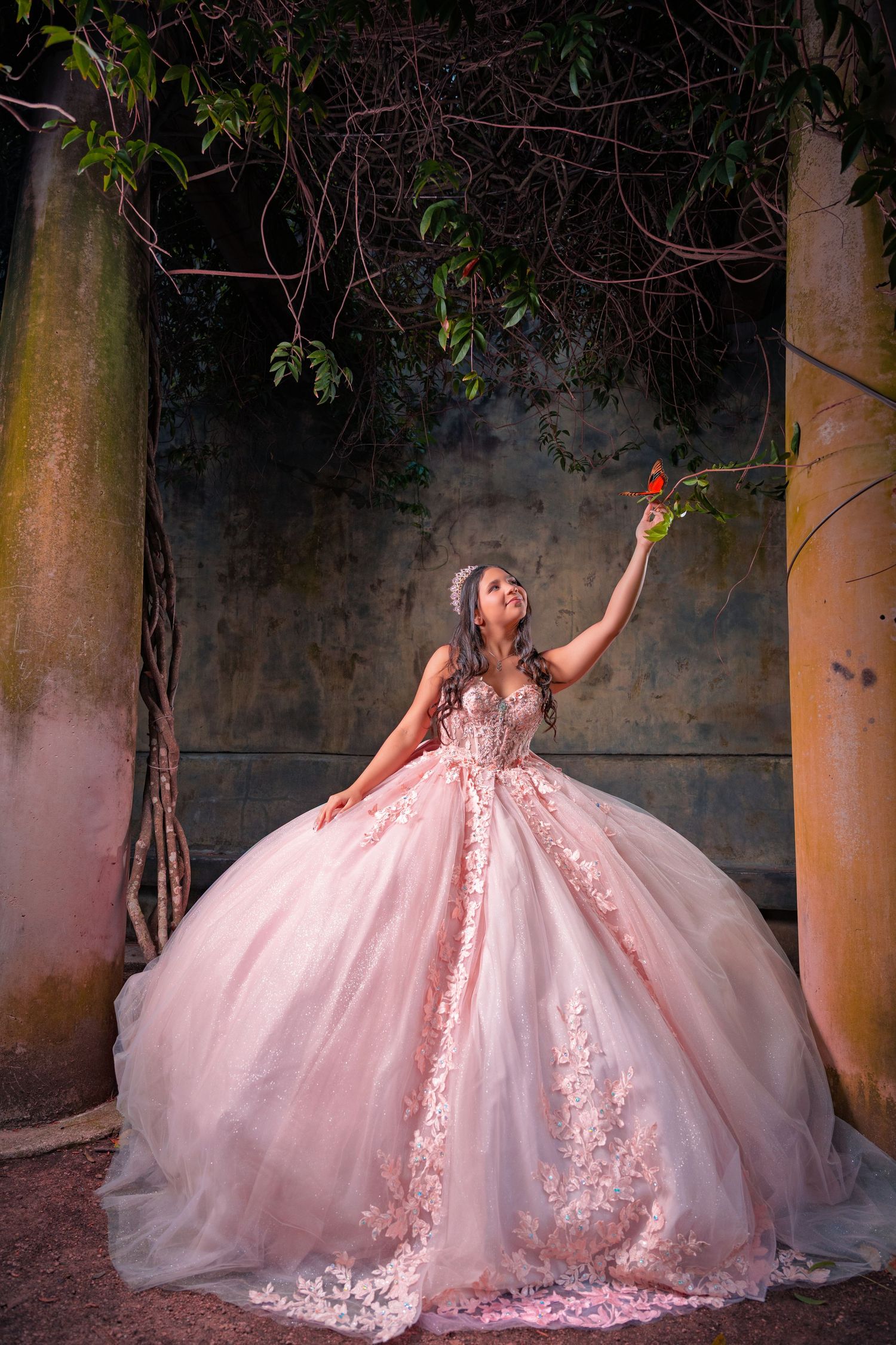 Stunning blush pink princess ball gown with intricate lace details shown in a series of romantic outdoor portraits.