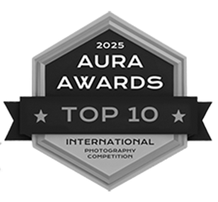 Black and white hexagonal award badge for 2025 Aura Awards Top 10 International Photography Competition.
