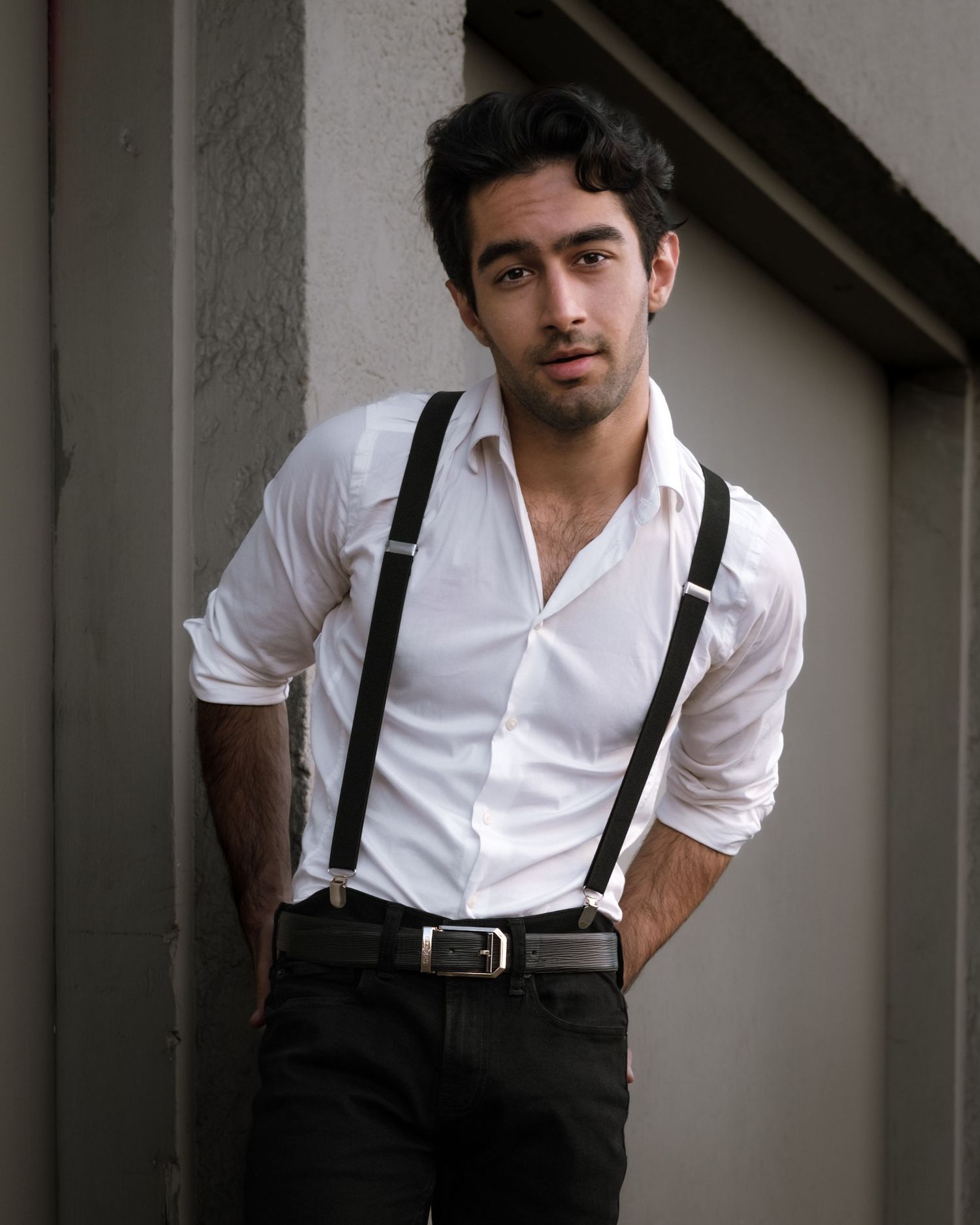 Man in white shirt with suspenders, dark urban backdrop, West End, professional portrait, North Vancouver
