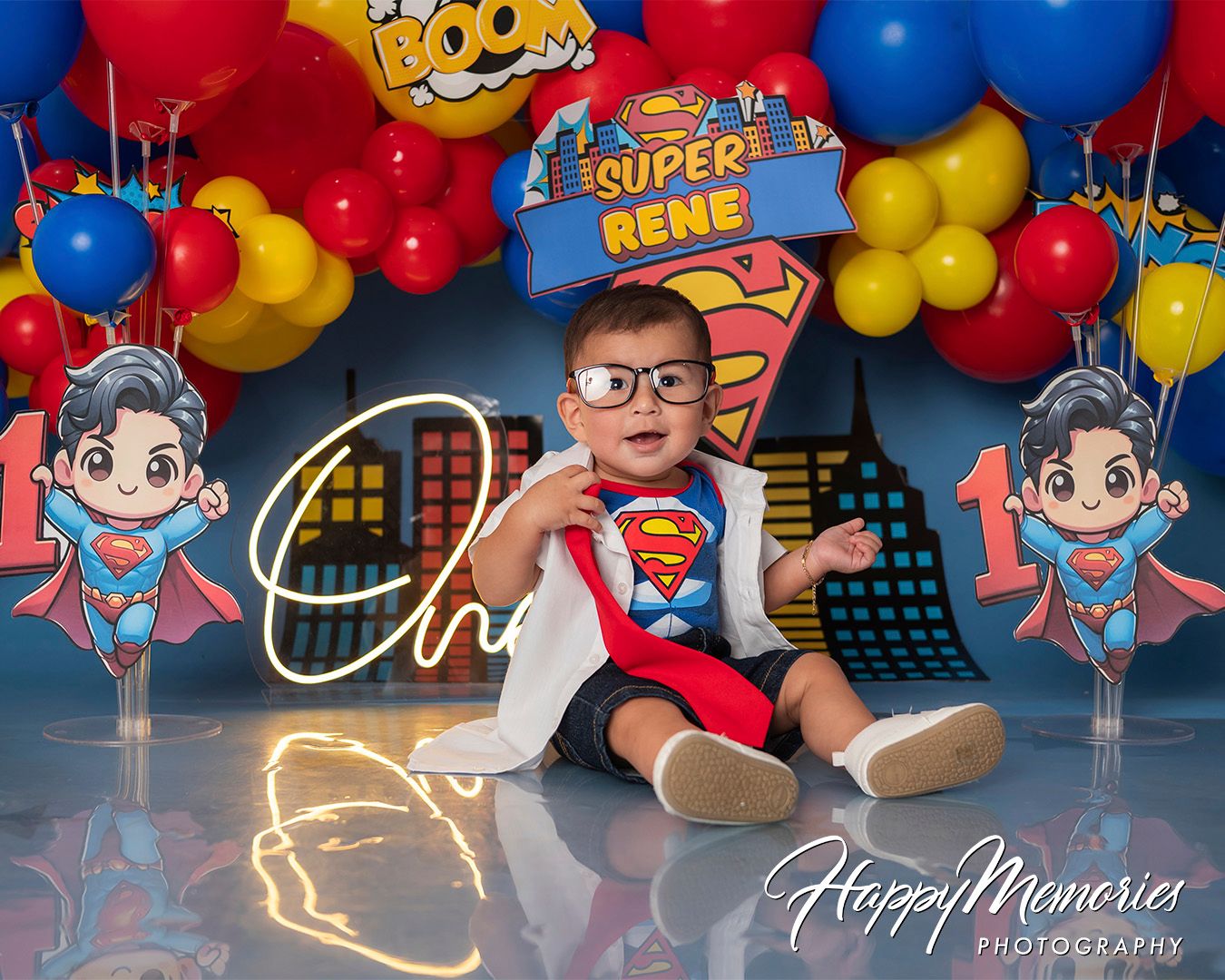Superhero themed party setup with red and blue balloons and comic book style decorations.