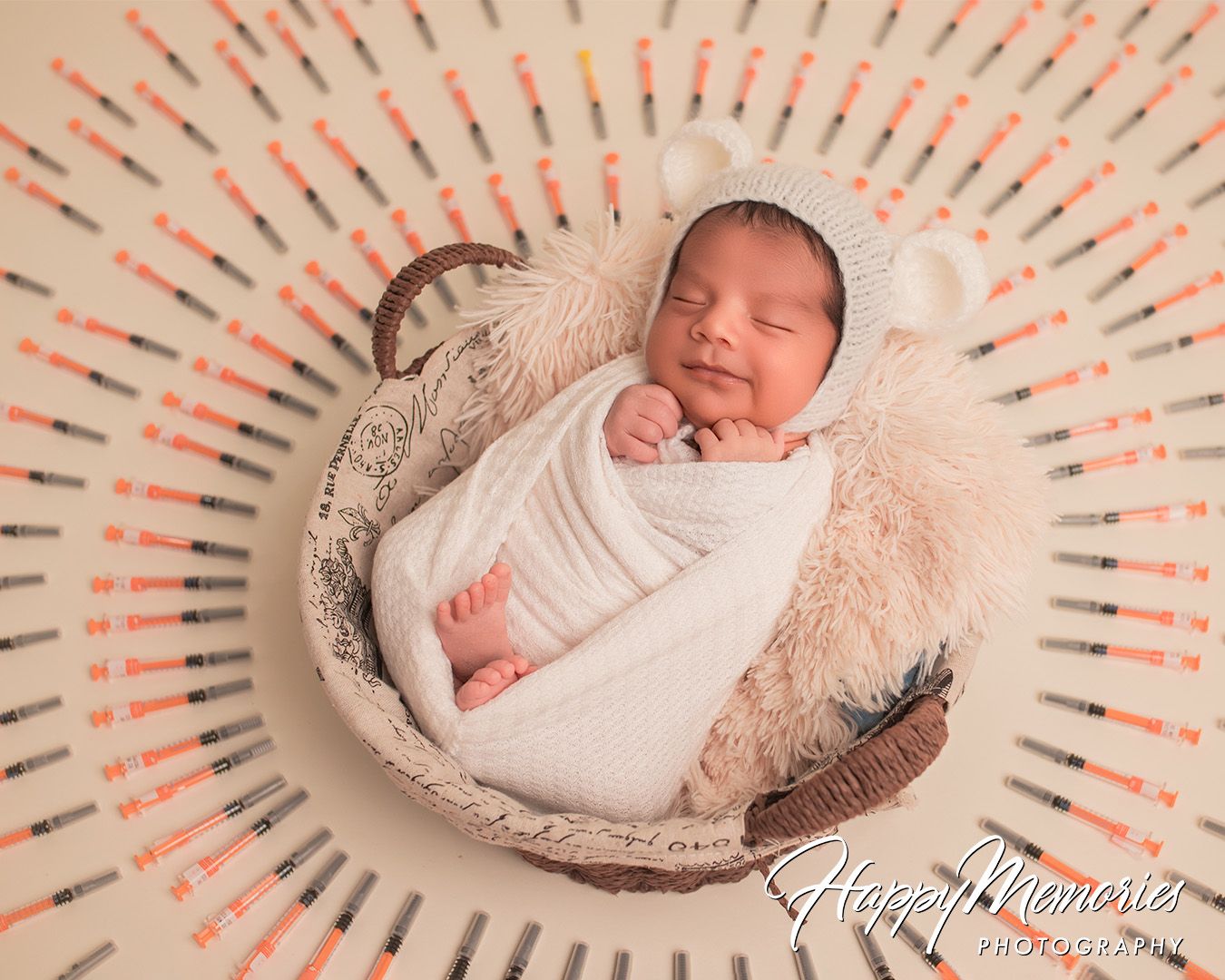 Artistic newborn photos with baby wrapped in white on circular patterned background.