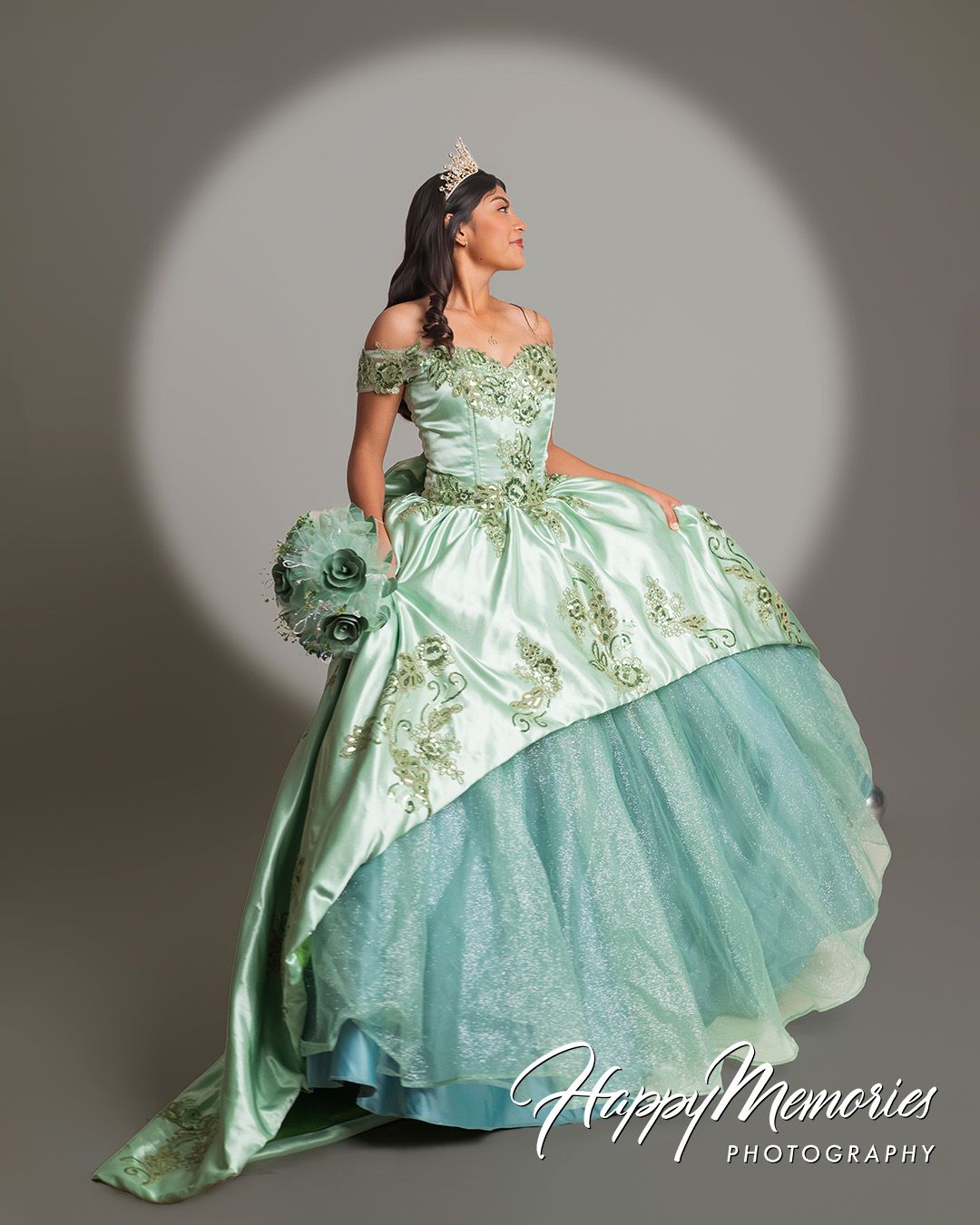 Elegant mint green ball gown photo series with dramatic lighting and poses.