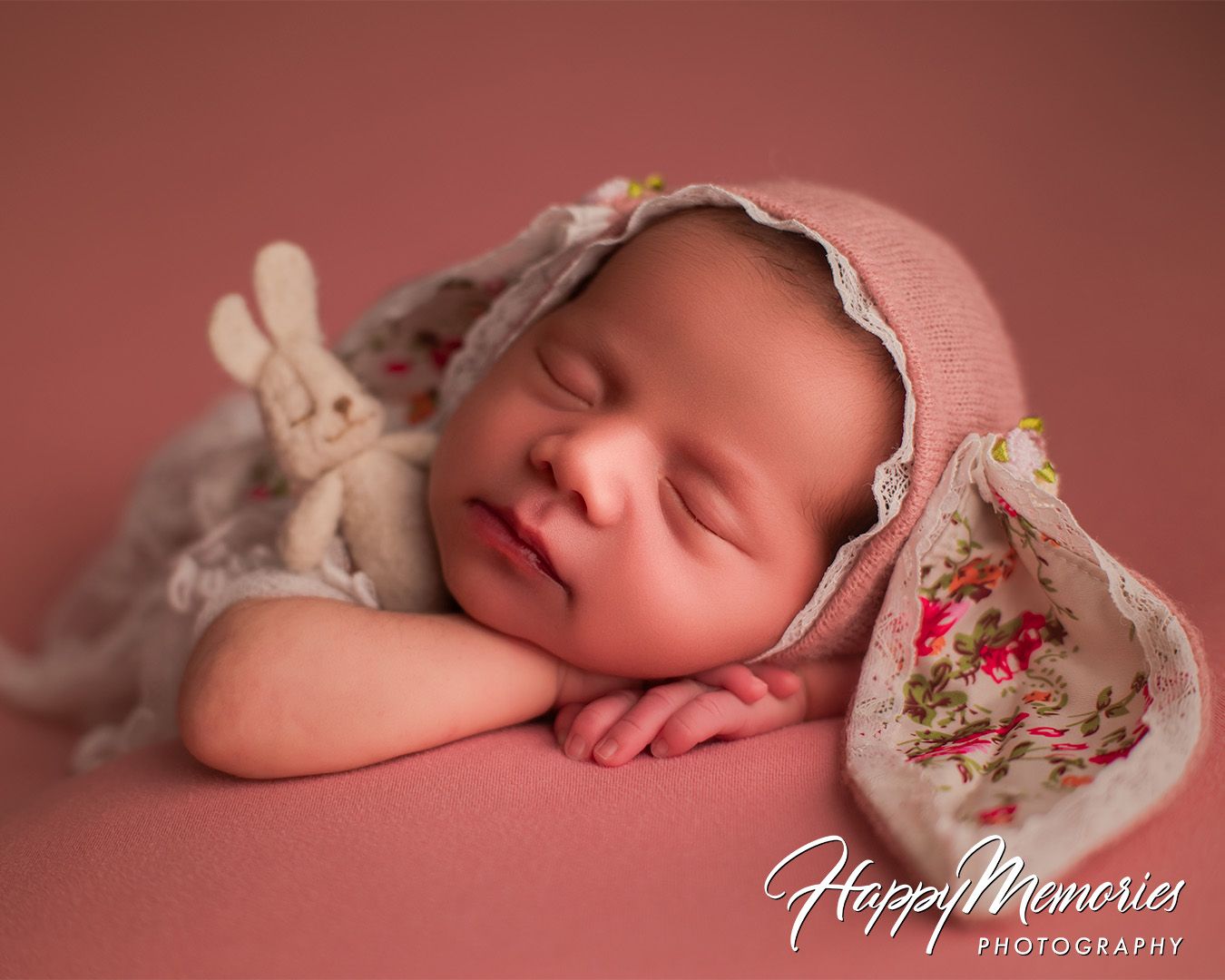 Delicate newborn portraits featuring baby in antique-style bonnet with floral details.