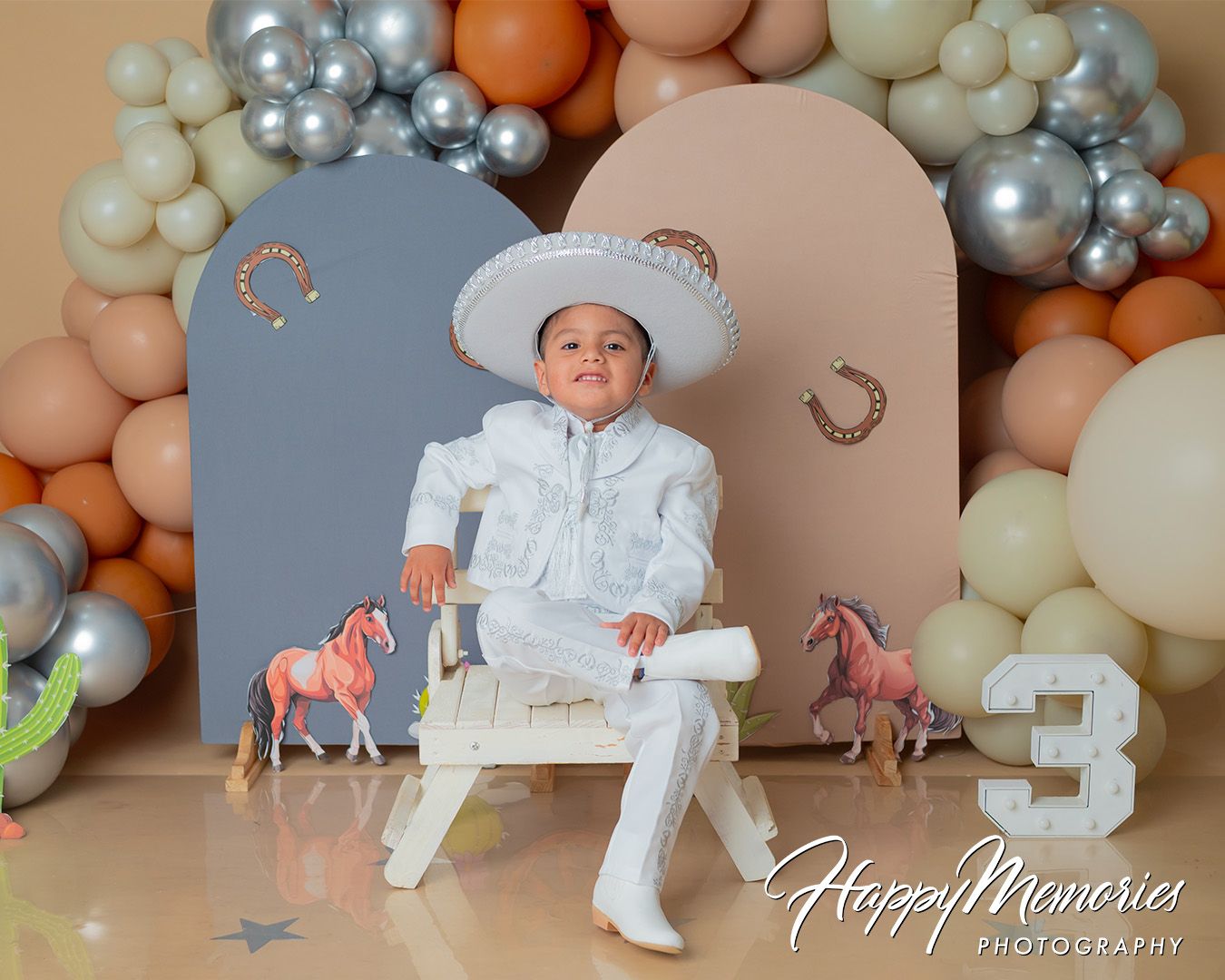 Elegant silver, peach and white balloon arrangement with decorative elements.