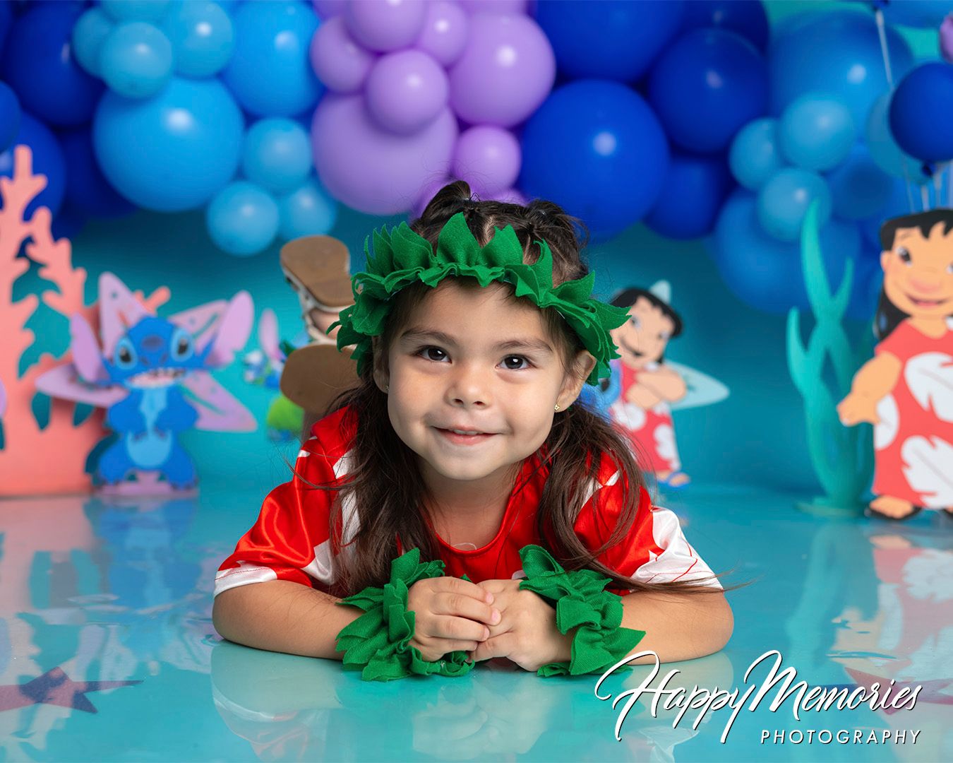 Whimsical underwater themed party setup with blue and purple balloon decorations.