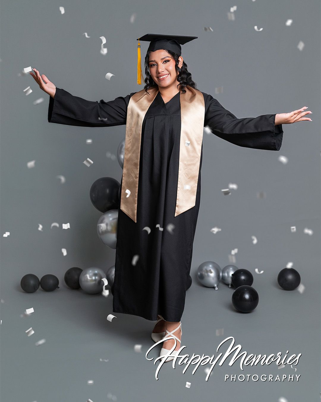 Celebratory graduation photo shoot with confetti and festive atmosphere.