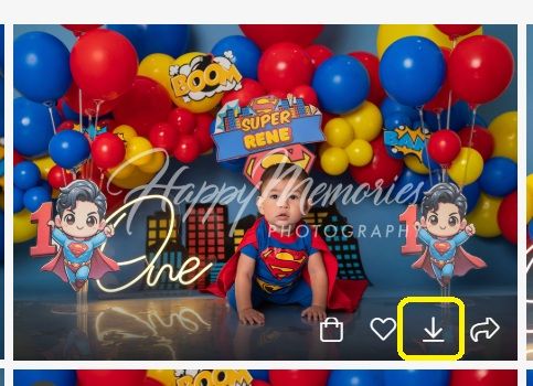 Superman themed birthday photoshoot setup with cartoon decorations and balloon arch.