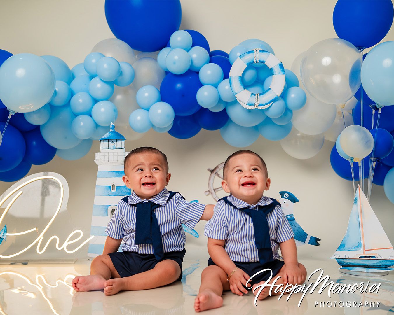 Blue and white balloon garland creates an elegant backdrop for a celebration.
