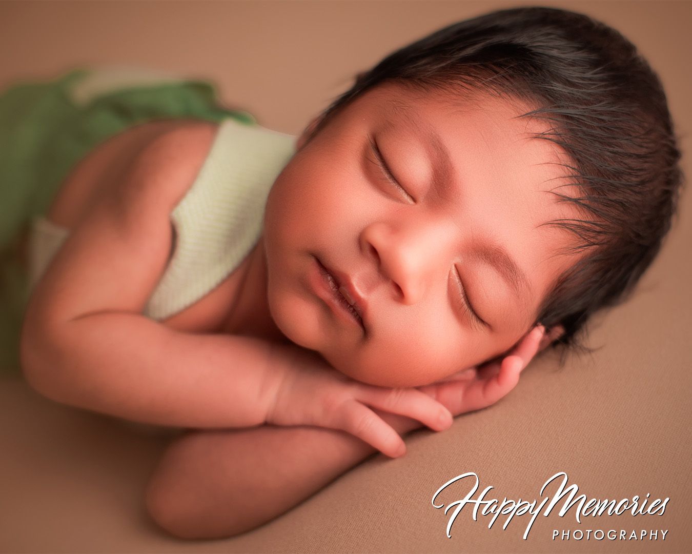 Artistic newborn portrait series with soft brown tones and gentle lighting.