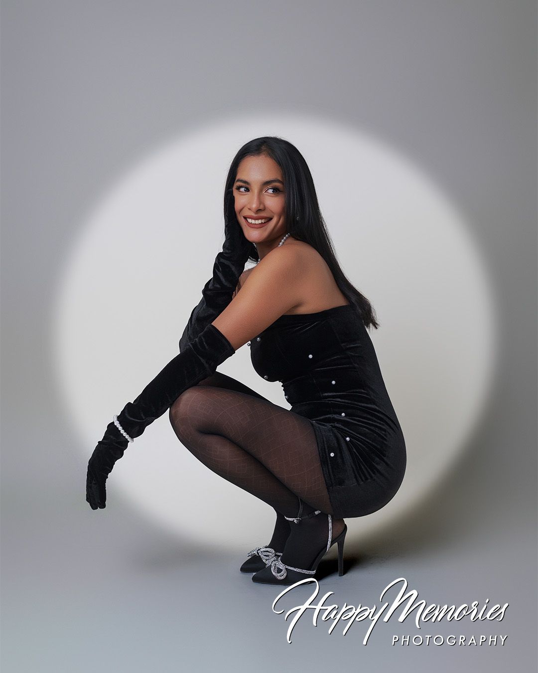 Dynamic black outfit photo series with dramatic shadows and poses.