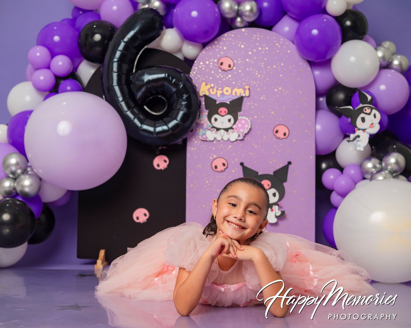 Purple and silver balloon arrangement with black accents creating an elegant birthday photo backdrop.