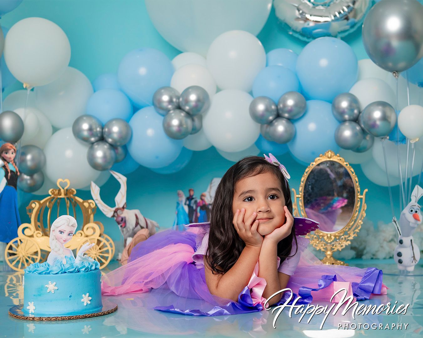 Dreamy birthday photoshoot setup with turquoise balloons, silver accents, and princess crown decorations.