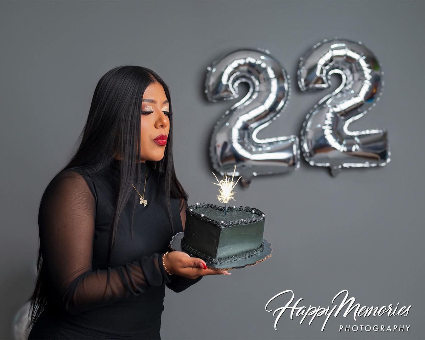 Artistic sequence showing interaction with silver number balloons in studio setting.