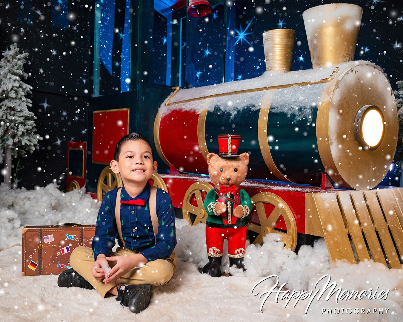 Christmas themed photography set with decorative train and snowy winter scene.