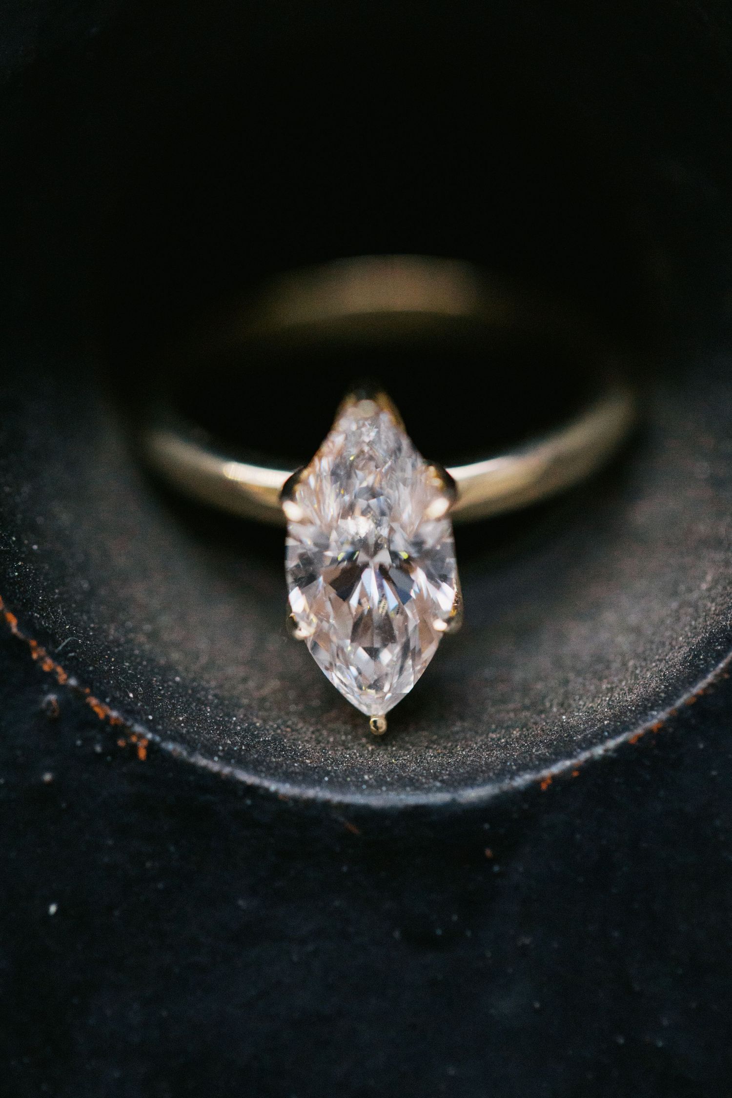 A heart-shaped diamond solitaire engagement ring shown in a sequence of increasingly closer macro shots on dark background.