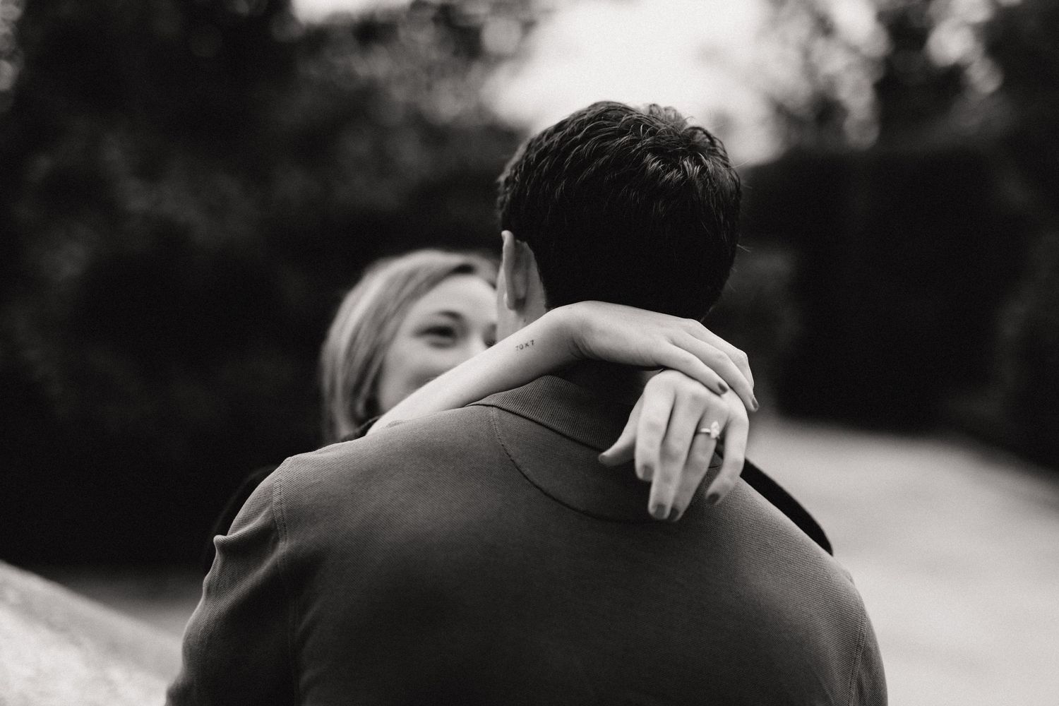 A black and white photo series showing a romantic embrace between two people in an intimate moment.