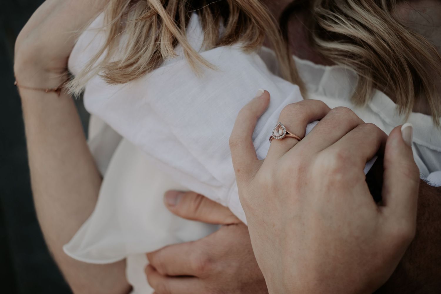 Close up of woman's hand and her engagement ring.