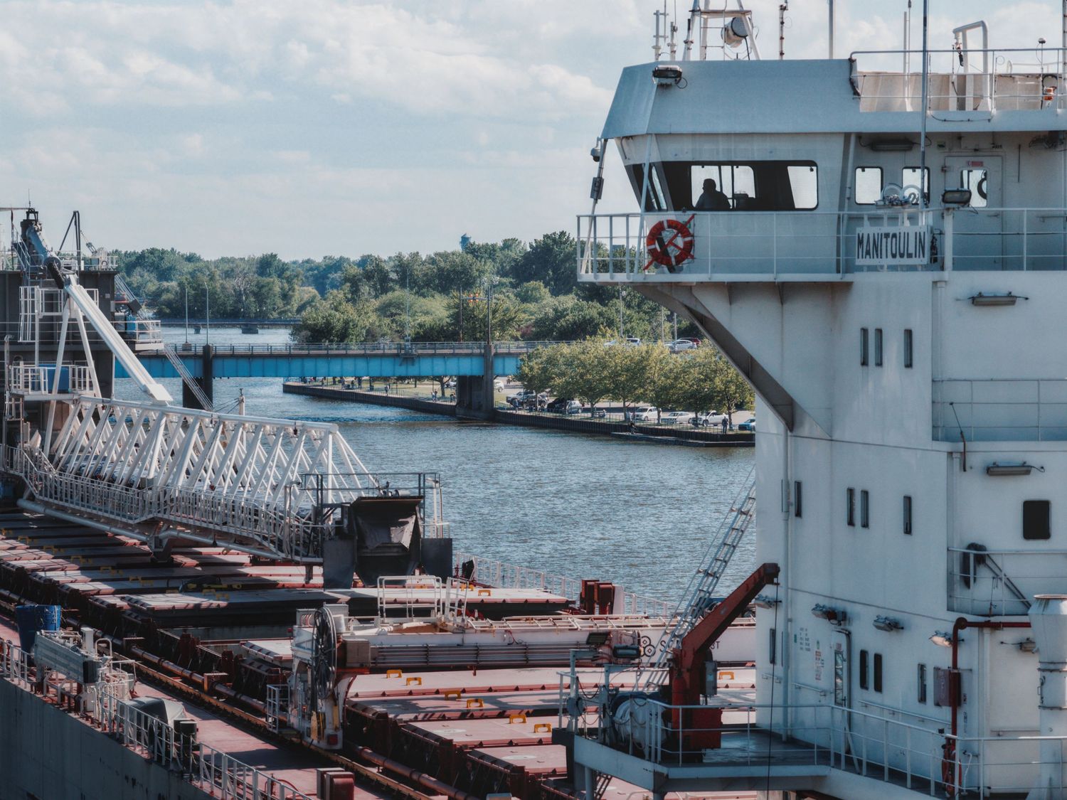 Silhouette shot of Great Lakes freighter Menominee crew as she steams up the Saginaw River in Bay City, Michigan