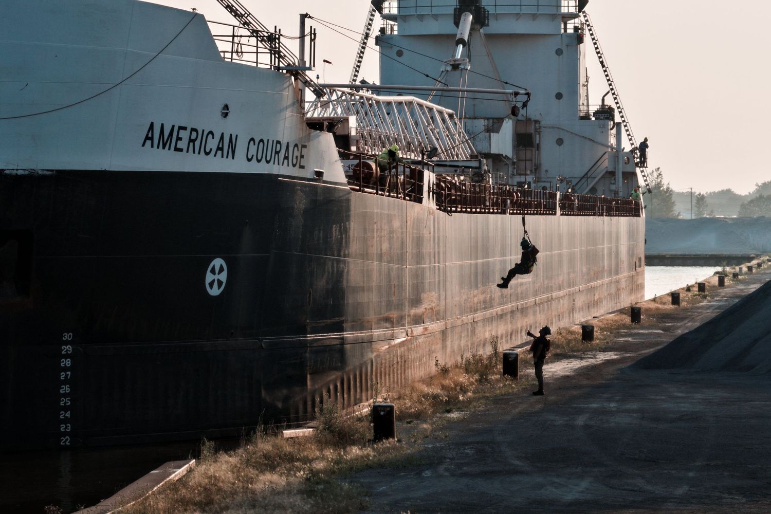 Great Lakes freighter American Courage arriving in Bay City dock with shore party landing