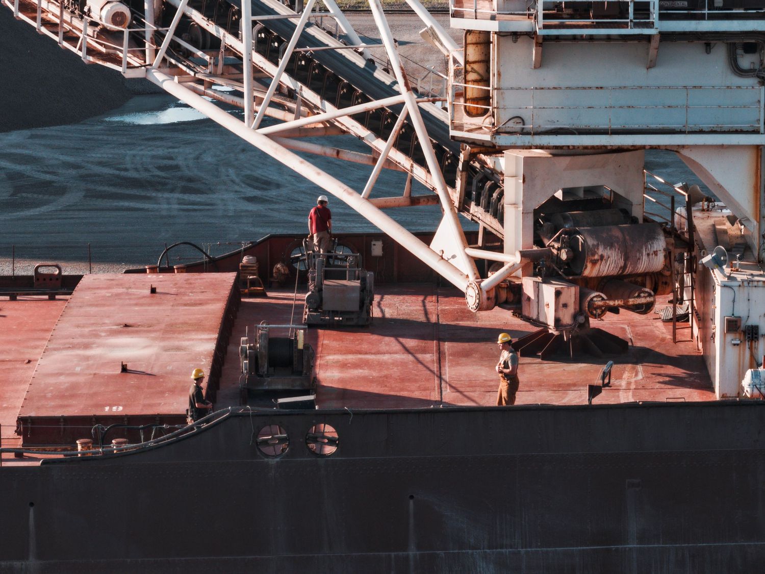 Crew supervising offloading on Great Lakes barge Pathfinder in Bay City, Michigan