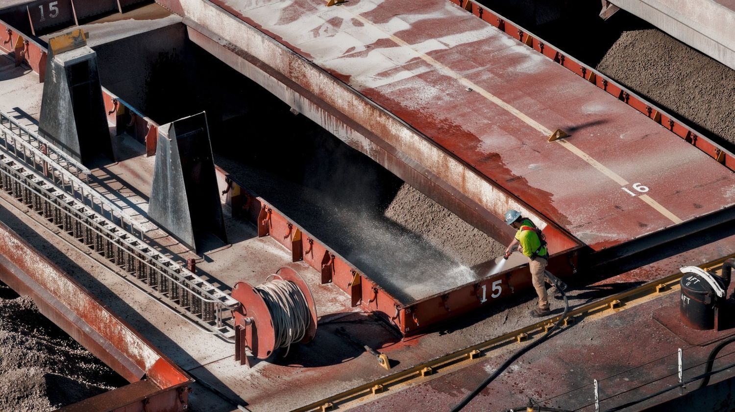 Deck crew sprays down a hatch on a Great Lakes bulk freighter