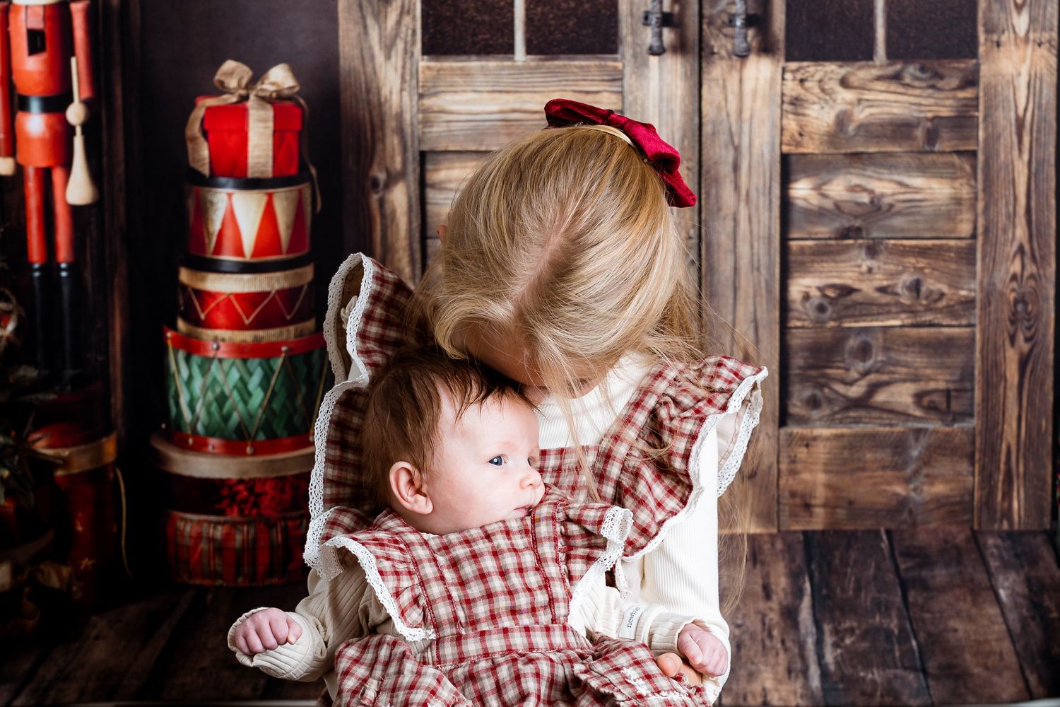 Christmas themed portraits with red accents and rustic decor against wooden backdrop.