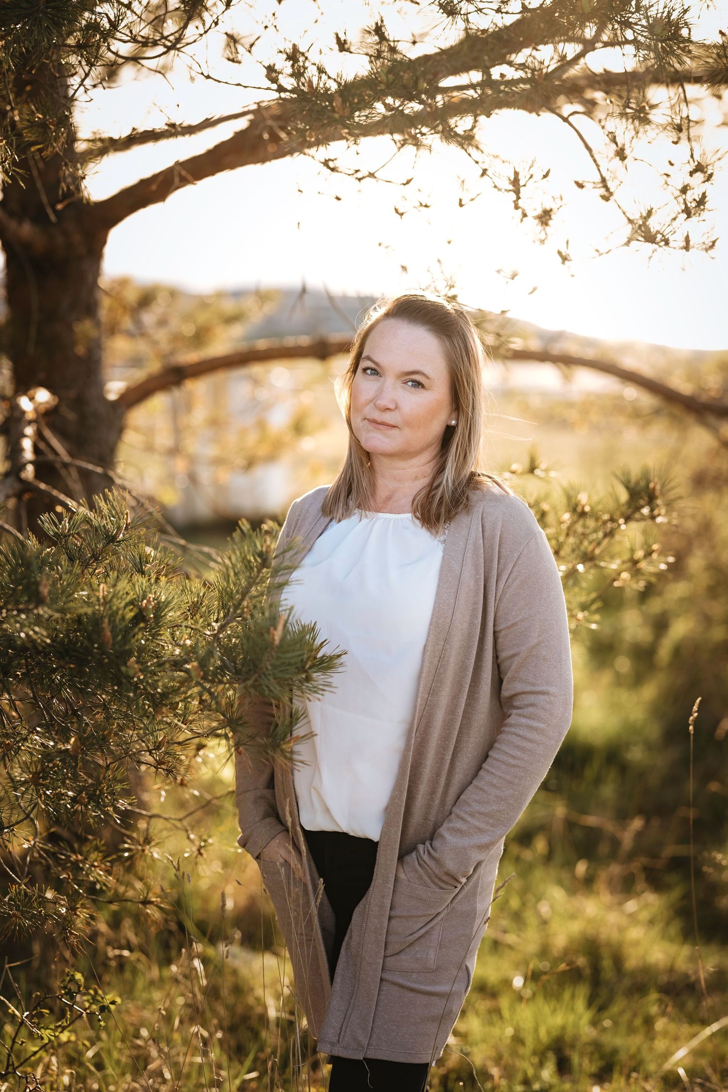 Outdoor portrait session at golden hour with trees and natural lighting.