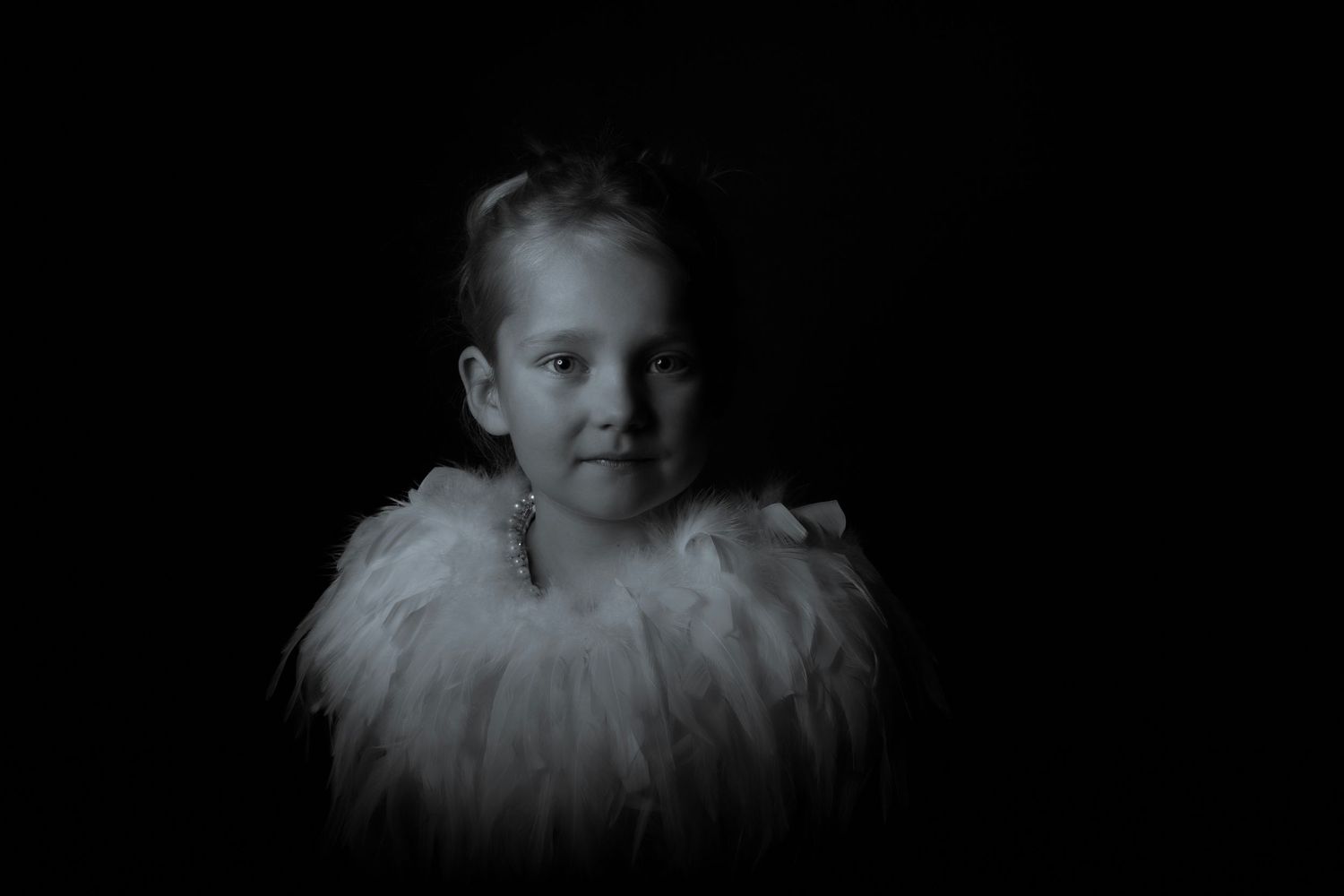 Dramatic black and white portrait featuring white feathered costume.