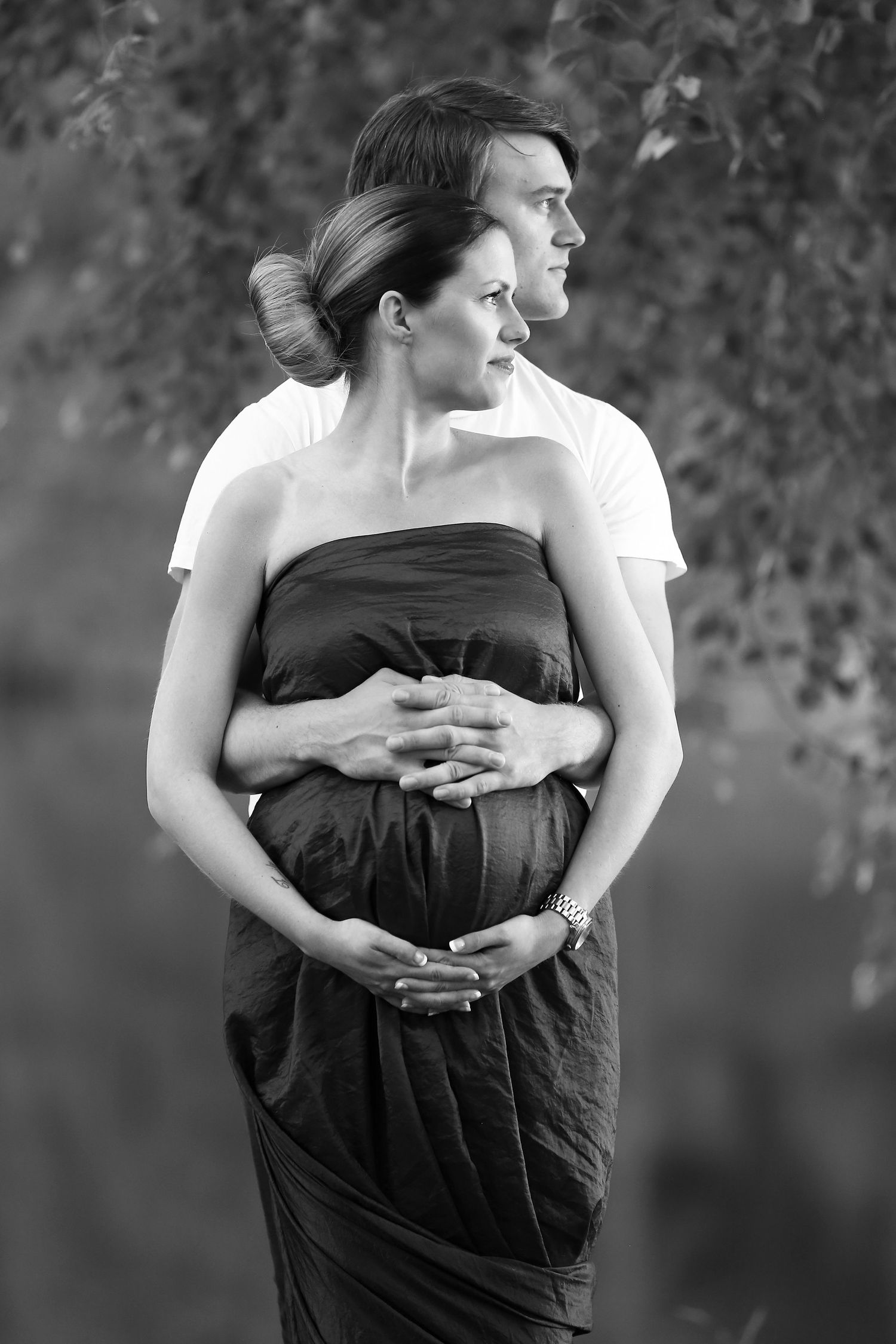 Black and white maternity couple photos showing tender embrace.