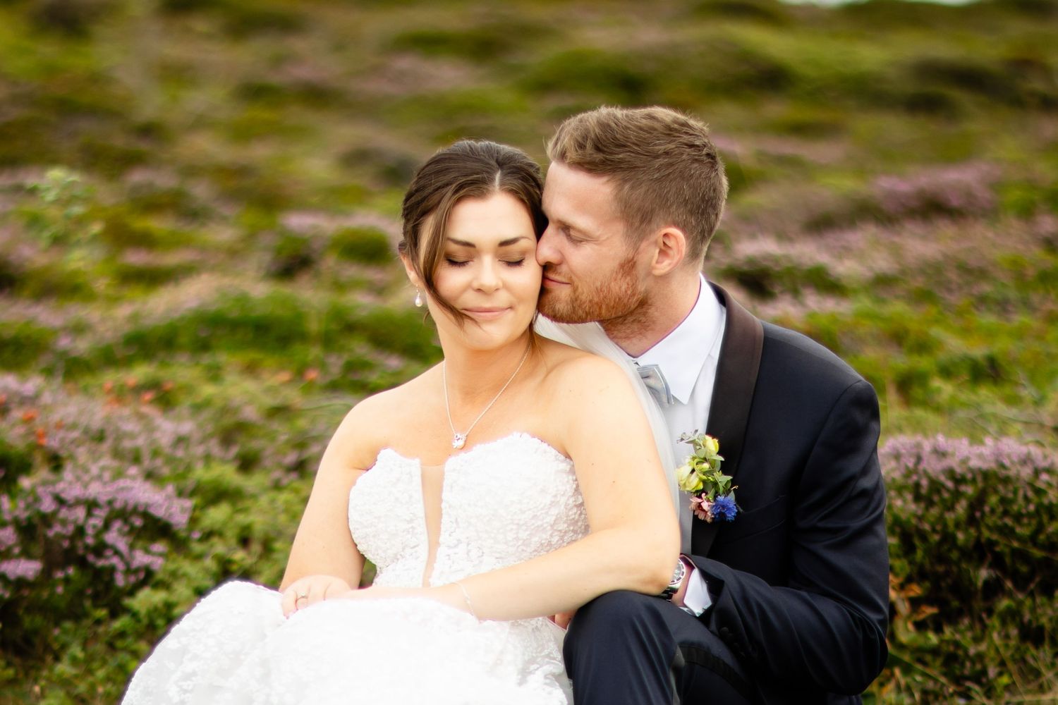Romantic wedding portraits captured in scenic moorland setting.
