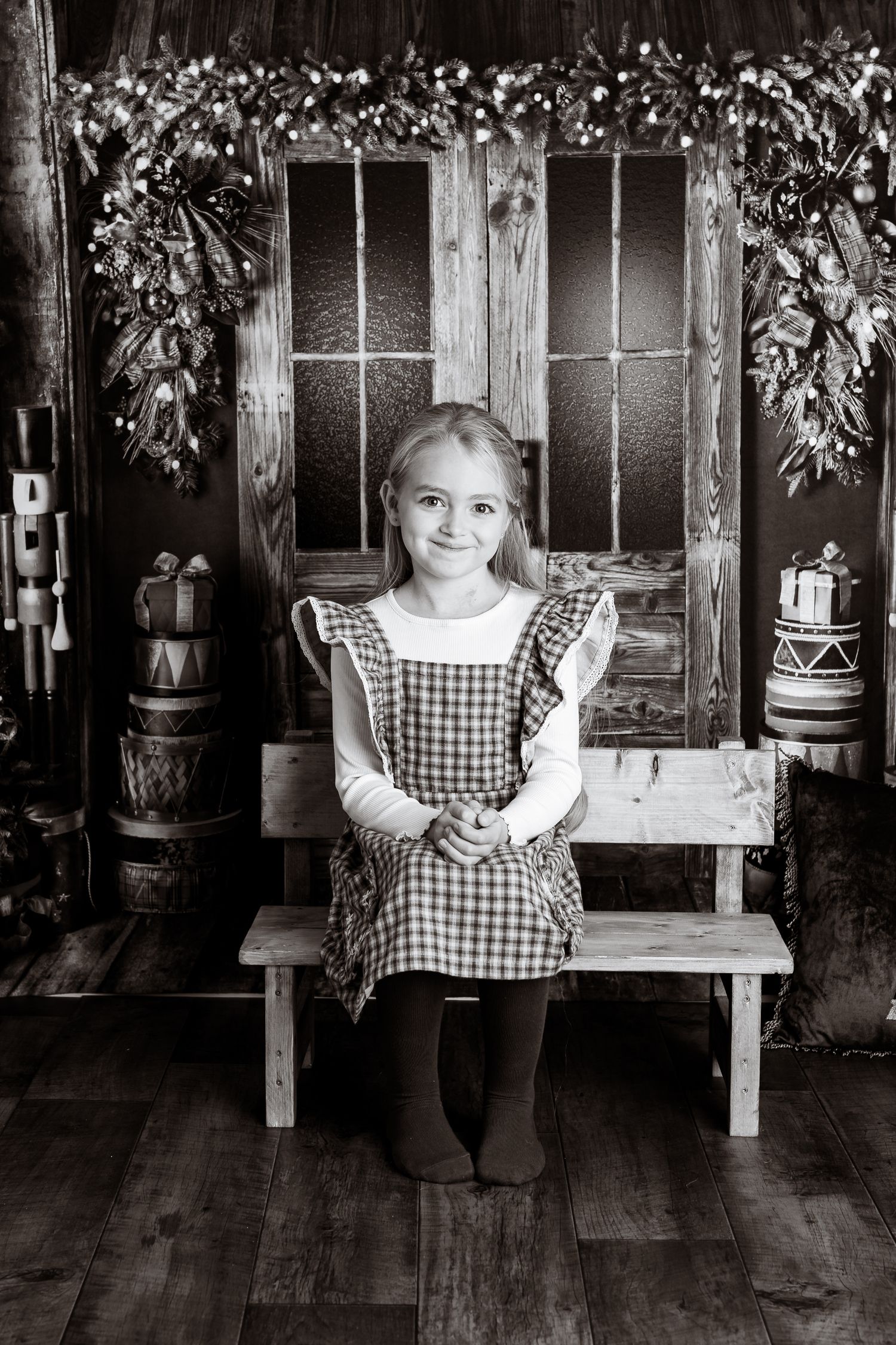 Series of black and white photos featuring a gingham dress against a vintage wooden wall setting.
