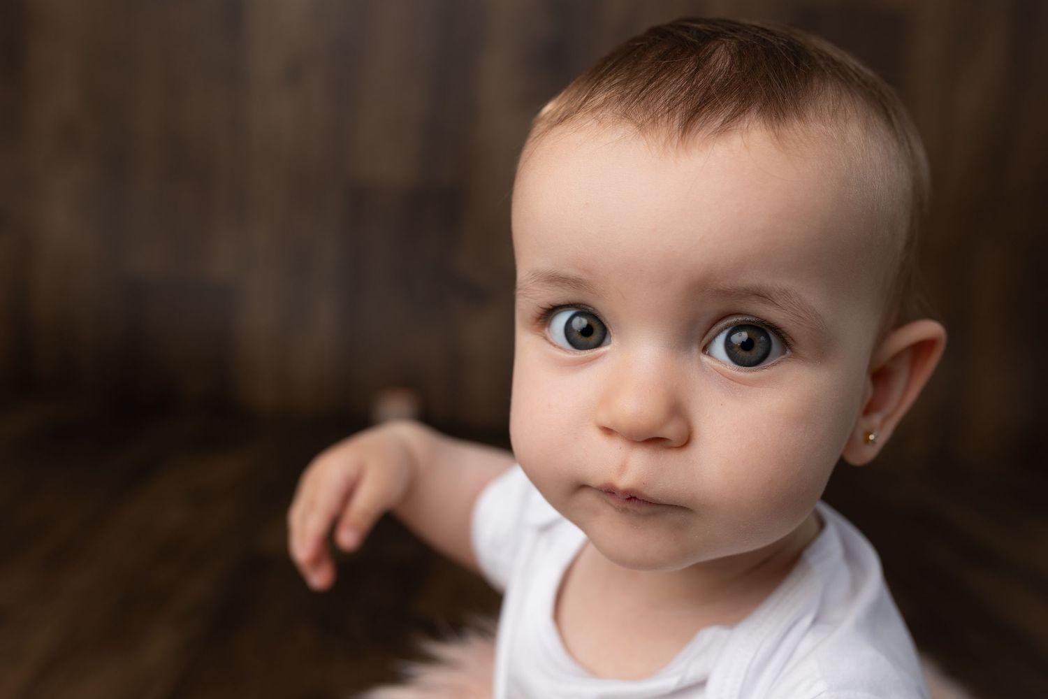 Close-up portrait with bright blue eyes and white dress.