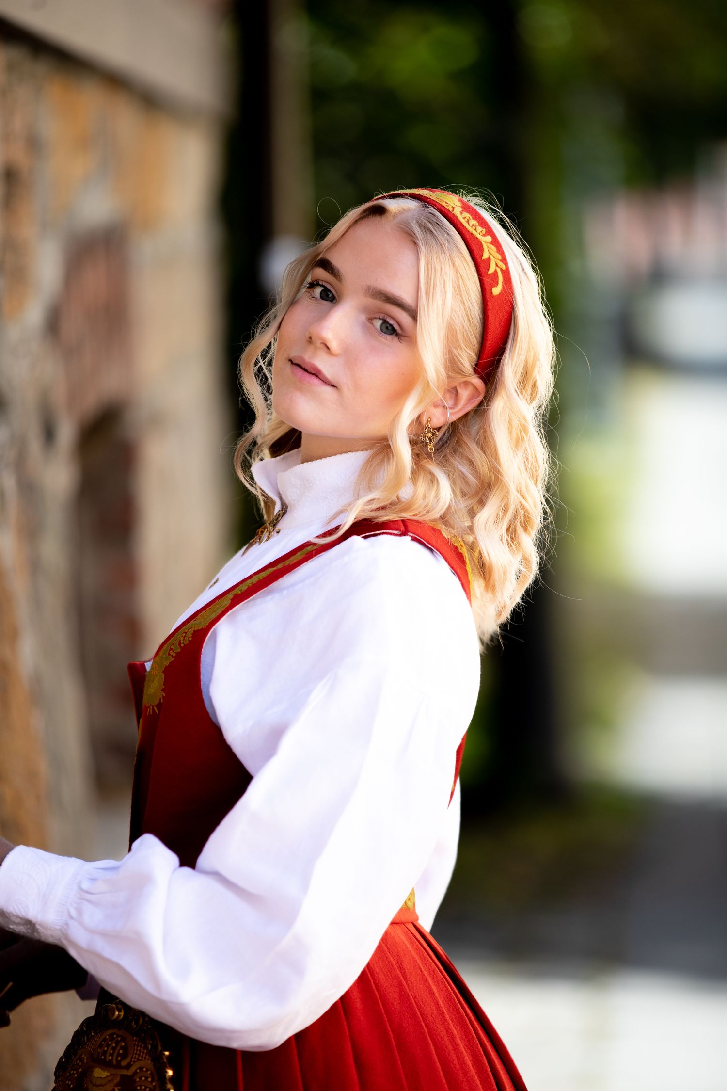 Norwegian bunad costume photographed in natural outdoor lighting.