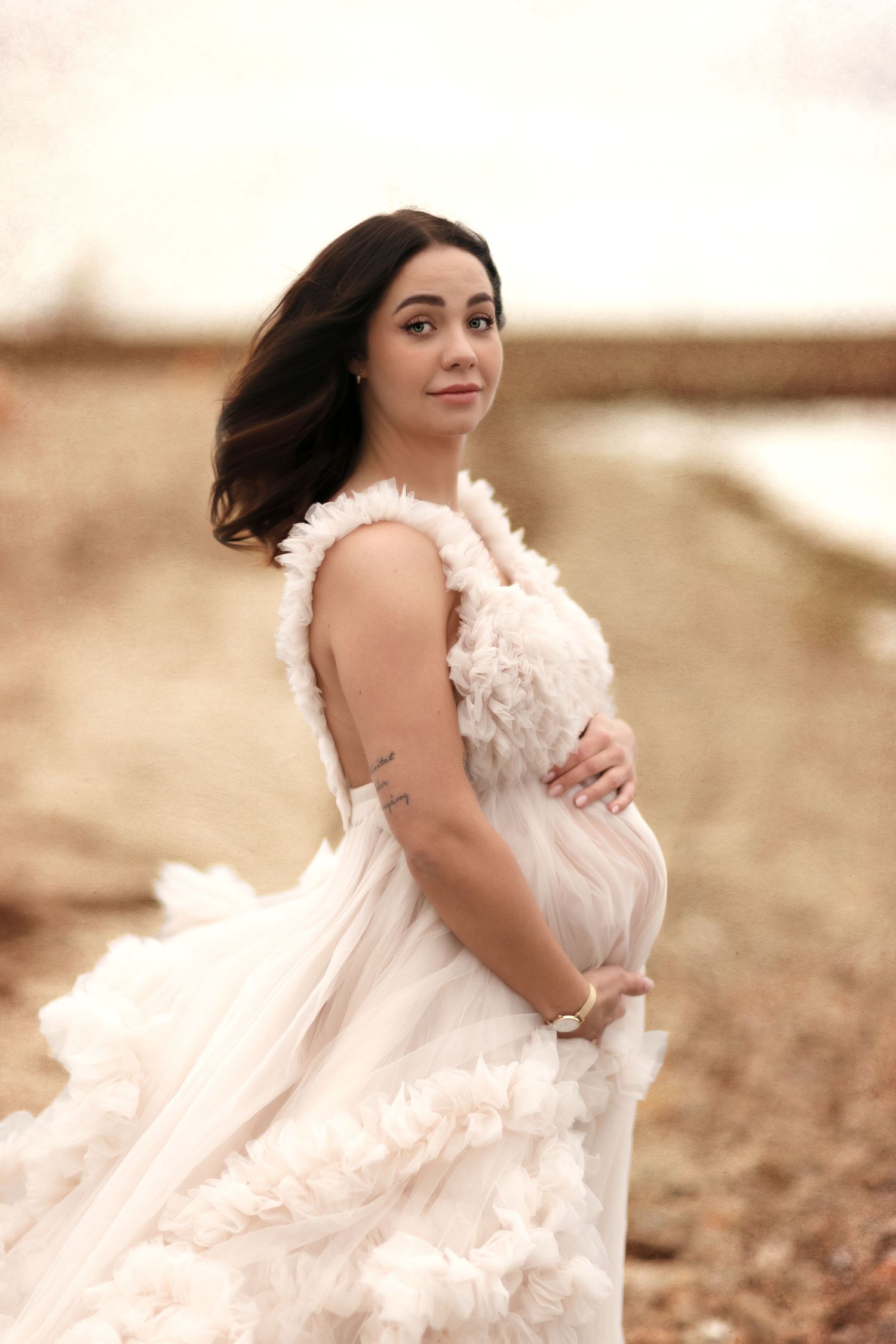 Dreamy sepia-toned maternity portraits with billowing white dress.