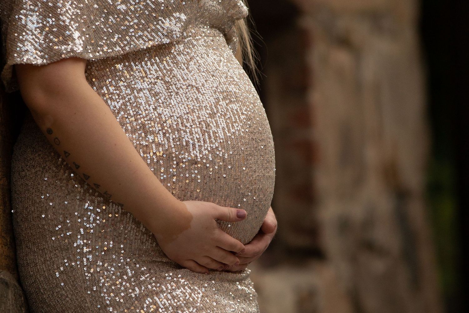 Close-up of sparkly sequined maternity gown.