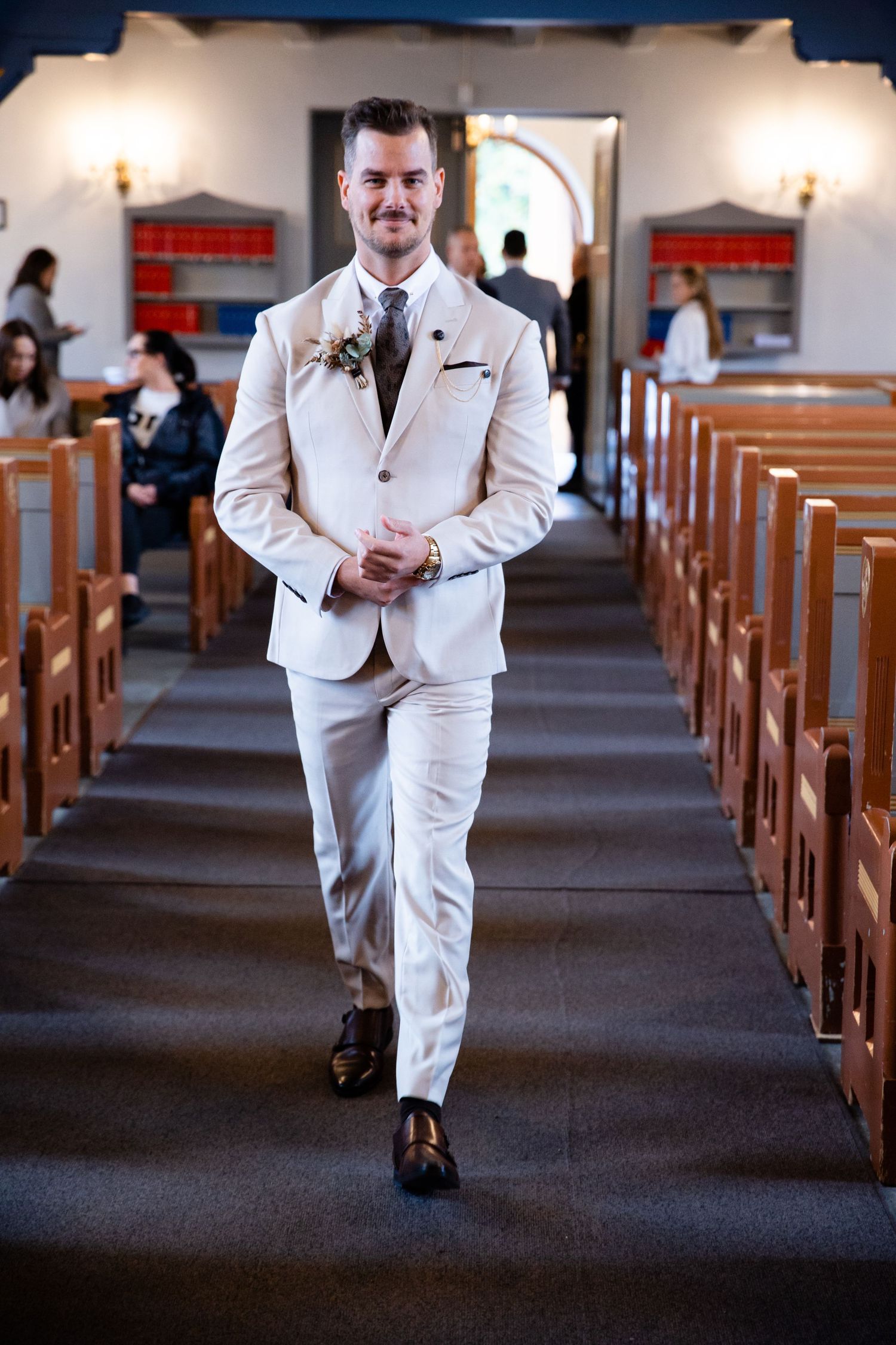 A sequence of wedding photos showing someone walking down a church aisle in a white suit.