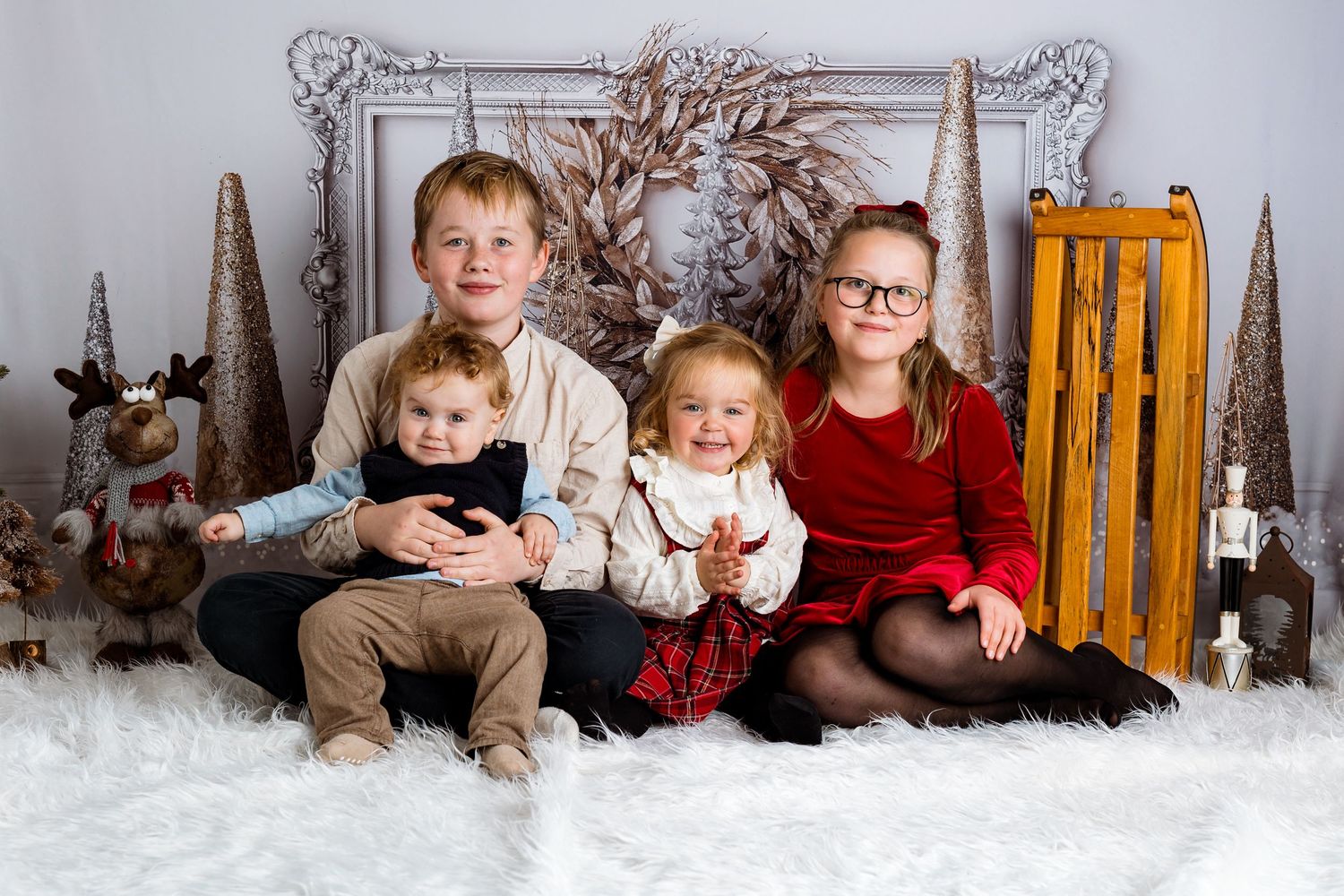 Winter themed studio photography session with snow and rustic decorations.
