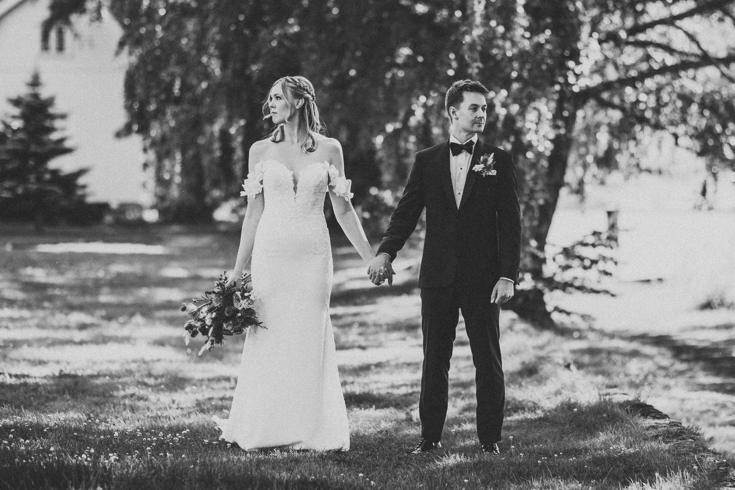 Black and white wedding photos taken outdoors with trees in the background.