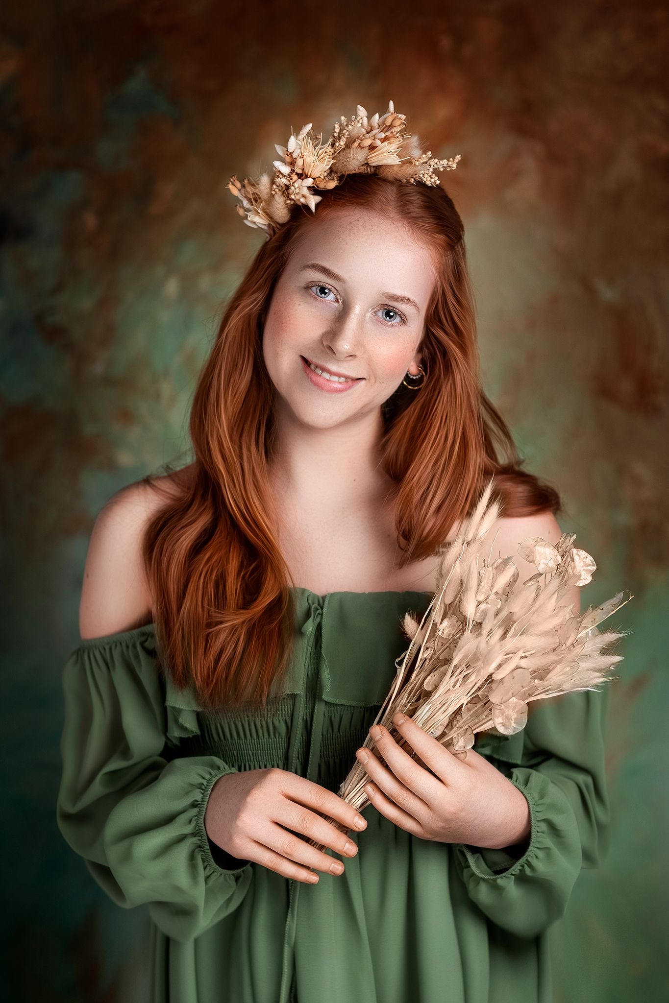 Artistic portrait with dried wheat stalks against a moody dark green and brown background.
