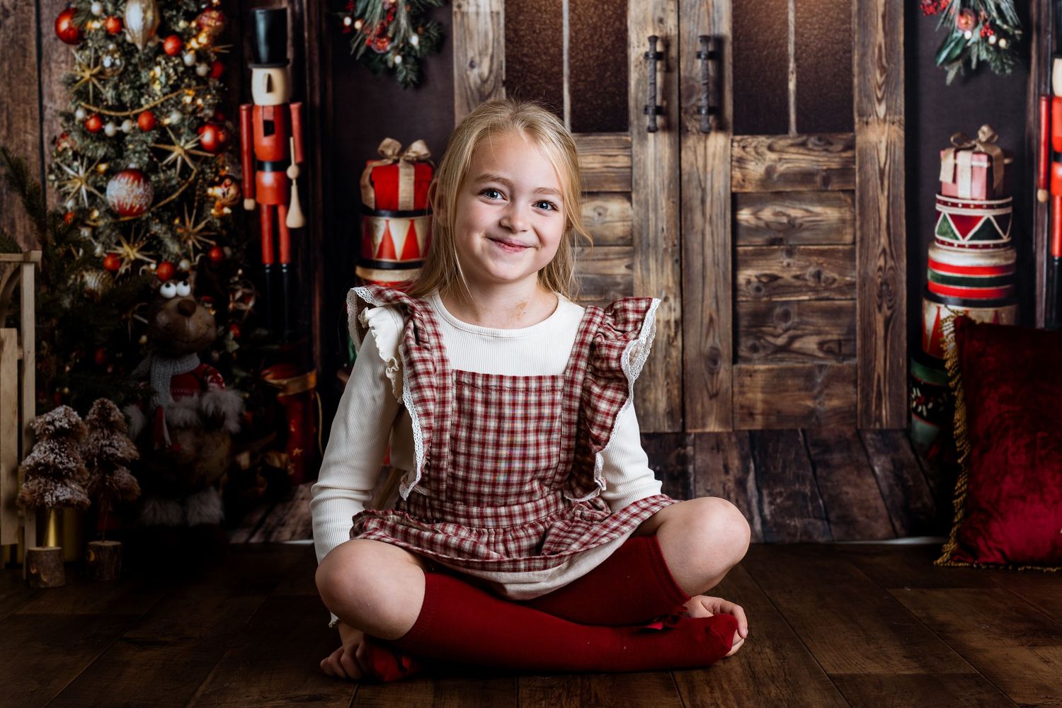 Christmas themed photo series with red decorations and rustic wooden backdrop.