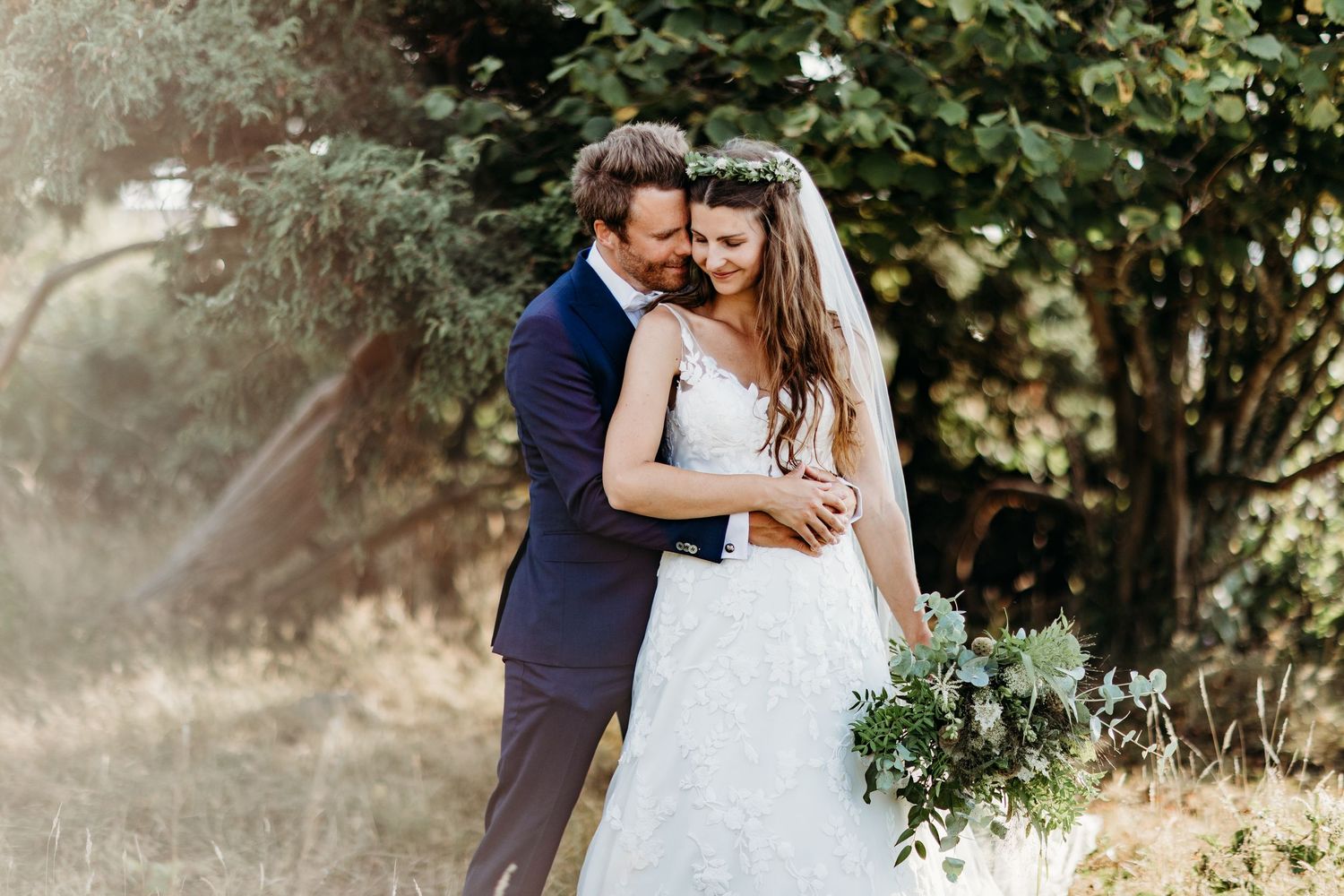Romantic outdoor wedding portraits captured in natural sunlight.