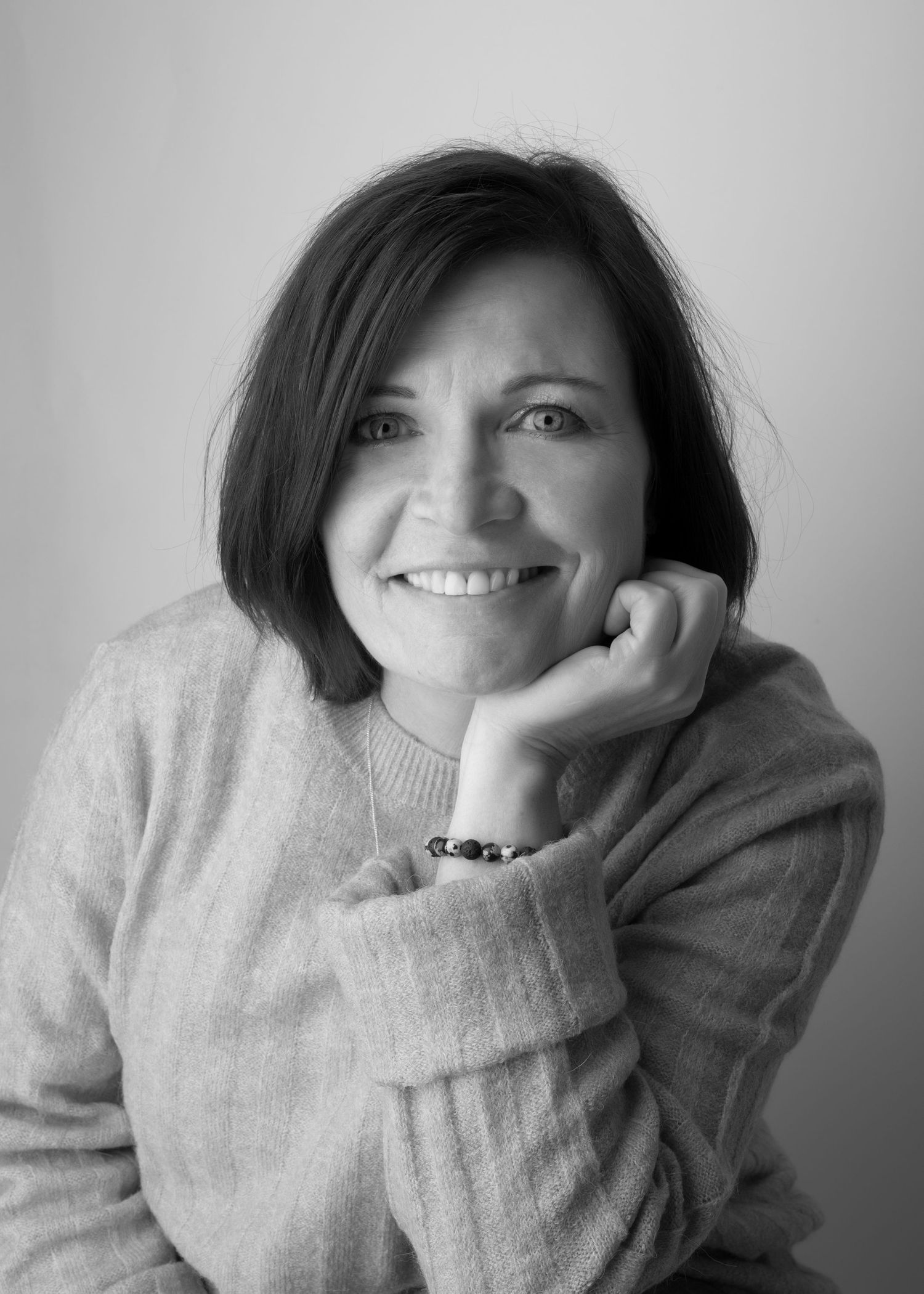 Artistic black and white portraits showing person in cozy sweater.